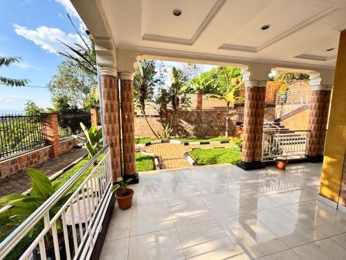 a porch of a house with a view of a garden at Sunset suit by Iwacu Stays in Kigali