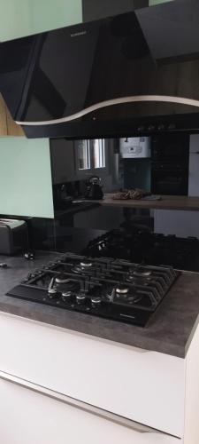 a kitchen with a stove top in a kitchen at Magnifique appartement avec terrasse au centre Epinal in Épinal