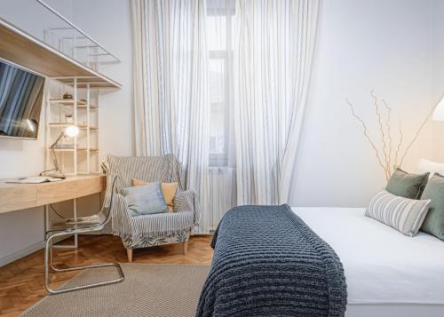 a bedroom with a bed and a desk and a chair at Cozy House Apartment Cluj Central in Cluj-Napoca