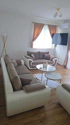 a living room with a couch and a table at Golden Sky in Cazin