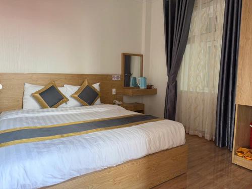 a bedroom with a large bed and a window at Soda Hotel Đà Lạt in Da Lat