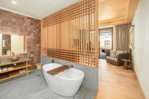 a bathroom with a bath tub in a room at Clevia, San Miguel de Allende, Autograph Collection in San Miguel de Allende