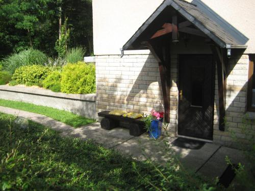 a small shed with a table and flowers in it at Ferienwohnung am Wäldchen in Kurort Gohrisch