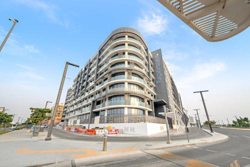 a large building on the corner of a street at Spacious 3BR Eco Stay Masdar City Abu Dhabi Near Airport & Yas Island in Abu Dhabi