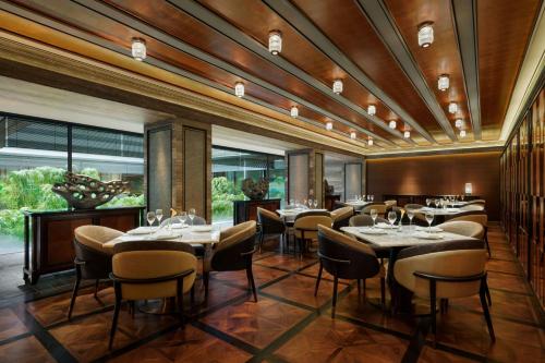 a restaurant with tables and chairs in a room at The Ritz-Carlton Kyoto in Kyoto