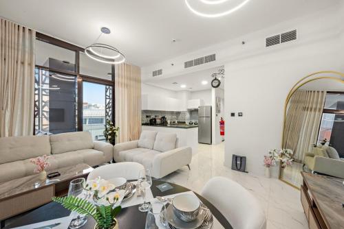 a living room with a couch and a table at Spacious 3BR Eco Stay Masdar City Abu Dhabi Near Airport & Yas Island in Abu Dhabi