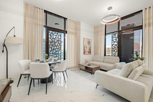 a living room with a couch and a table at Spacious 3BR Eco Stay Masdar City Abu Dhabi Near Airport & Yas Island in Abu Dhabi