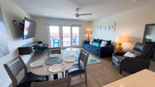 a living room with a table and a couch at La Internacional 313 home in South Padre Island