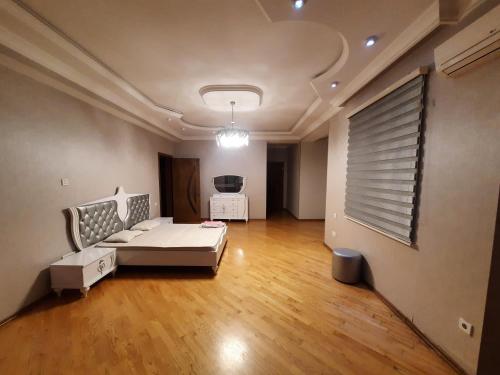 a living room with a couch and a table at Super Villa in Mardakan