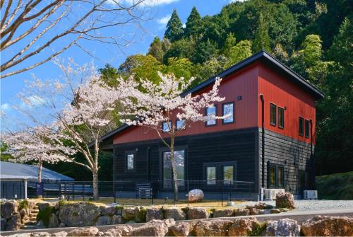 a red and black house with a tree at Class Besso Ise - Vacation STAY 06605v in Iseji