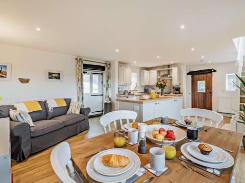a kitchen and living room with a table with food on it at 2 Bed in Matlock oc-92639 in Highpeak Junction