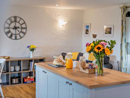 a kitchen with a counter with a vase of flowers on it at 2 Bed in Matlock oc-92639 in Highpeak Junction