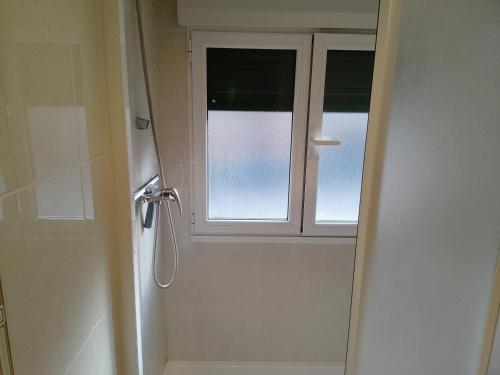 a bathroom with a shower and a window at Enlace kosta in Mendaro