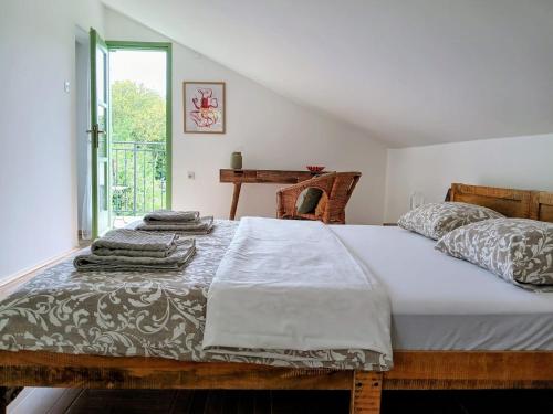 a bedroom with a bed with towels on it at House Barci in Barci