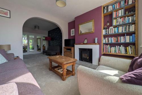 a living room with a couch and a fireplace at Cherry View House 3 Bed Garden Parking sleeps 8 in Bristol