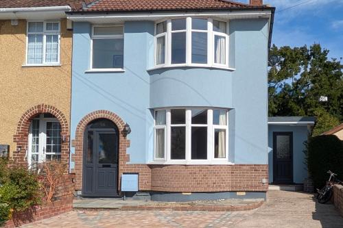 a blue house with a black door at Cherry View House 3 Bed Garden Parking sleeps 8 in Bristol