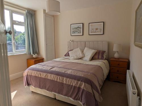 a bedroom with a bed and a window at Cherry View House 3 Bed Garden Parking sleeps 8 in Bristol