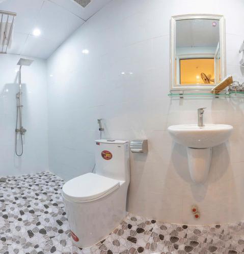 a bathroom with a toilet and a sink at Soda Hotel Đà Lạt in Da Lat