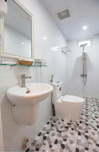 a bathroom with a sink and a toilet at Soda Hotel Đà Lạt in Da Lat