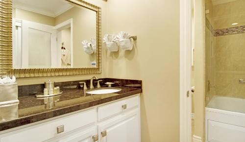 a bathroom with a sink and a mirror at Carriage House Inn in Carmel