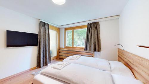 Postel nebo postele na pokoji v ubytování Abitaziun Gianda 5 - Pontresina