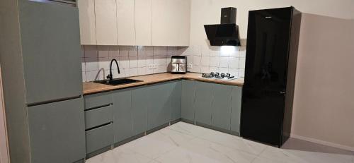 a small kitchen with a sink and a refrigerator at Villa Harmony Tianeti in Tʼianetʼi