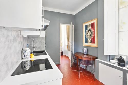 a kitchen with a sink and a table in it at Le jardin de Ponteves in Aix-en-Provence