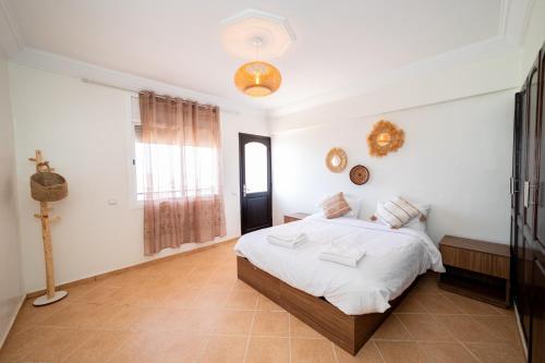 a bedroom with a bed and a window at Appartement Dar Tamraght in Tamraght Ouzdar