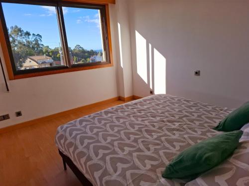 a bedroom with a bed and a large window at Apartamento independiente en Nigrán in Nigrán