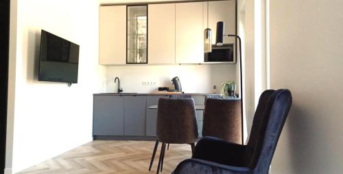 a kitchen with a table and chairs in a room at Luise LuXe Suites in Tallinn