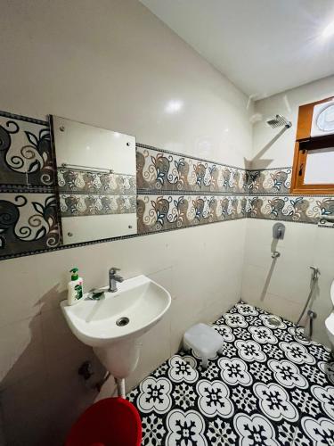 a bathroom with a sink and a mirror at Hotel Lotus Villa - Near Nehru Enclave Metro Station in New Delhi