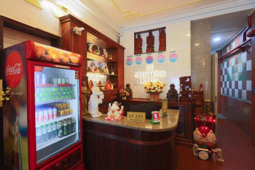 a candy store with a cocacola refrigerator in a store at Minh Hồng Hotel in Ho Chi Minh City