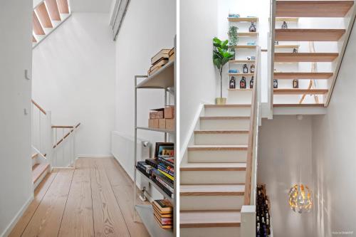 a staircase in a home with white walls and wooden floors at Townhouse with private Terrace- 5-minute walk from Tivoli in Copenhagen