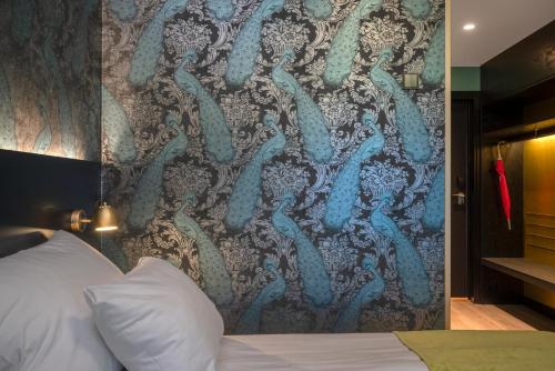 a bedroom with a wall with a mural of tentacles at Thon Hotel Oslo Airport in Gardermoen