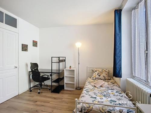 a bedroom with a bed and a desk and a chair at Rest and River in La Celle-sous-Gouzon