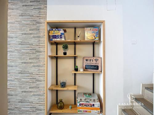 a book shelf in a room with a wall at Rest and River in La Celle-sous-Gouzon
