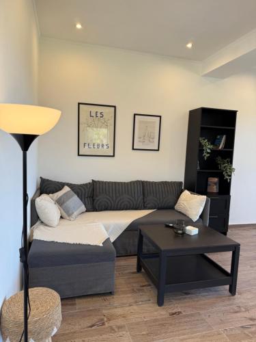 a living room with a couch and a table at Maison Soleil in Kastro Kyllini