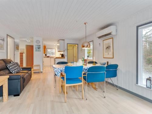 a dining room and living room with a table and chairs at Holiday Home Teofilka - 200m from the sea by Interhome in Sæby