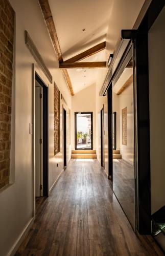 an open hallway with wood floors and a brick wall at Loft Prestige in Leiria