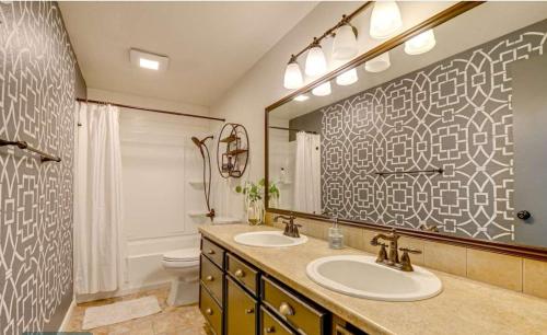 a bathroom with a sink and a toilet and a mirror at Family Paradise Hot Tub, Fire Pit n Play House in Mount Vernon