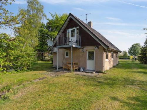 a small house with a balcony on a yard at Holiday Home Bendine - 100m to the fjord by Interhome in Storvorde