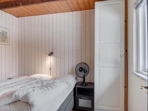 a bedroom with a bed and a desk with a mirror at Holiday Home Bendine - 100m to the fjord by Interhome in Storvorde