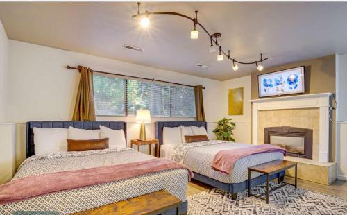 a bedroom with two beds and a fireplace at Family Paradise Hot Tub, Fire Pit n Play House in Mount Vernon