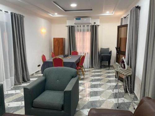 a dining room with a table and chairs at 2 cozy bedrooms in Lomé Sagbado in Komé