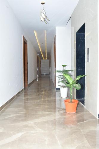 an empty hallway with plants in a building at Hotel Sky Suites in Gurgaon