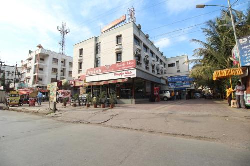 an empty street in a city with a building at Saish Hotel Shirdi in Shirdi