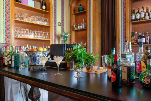 a bar with bottles of alcohol and glasses on it at Excelsior Palace Hotel in Taormina