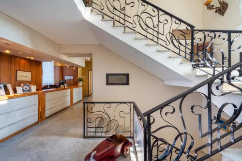 a spiral staircase in a home with a kitchen at Excelsior Palace Hotel in Taormina