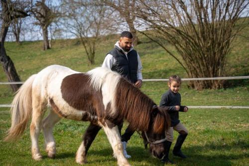 a man and a boy standing next to a pony at Ferienhaus Gersmühle in Satteldorf