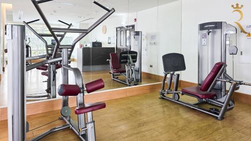 a gym with three treadmills and a mirror at 2BR Waterfront Lamar Residences Abu Dhabi in Al Qurayyah